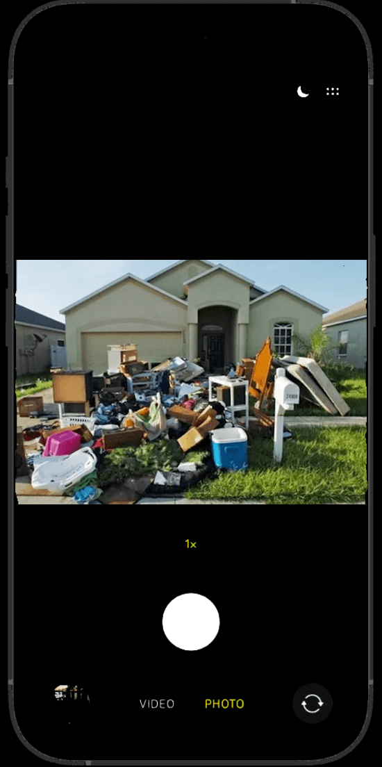 Customer photographing a pile of junk items for a pickup estimate
